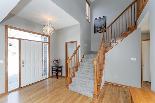 5078 Nicklaus Dr NW, Rochester, MN 55901 - entrance foyer featuring stairway, wood finished floors, and a chandelier