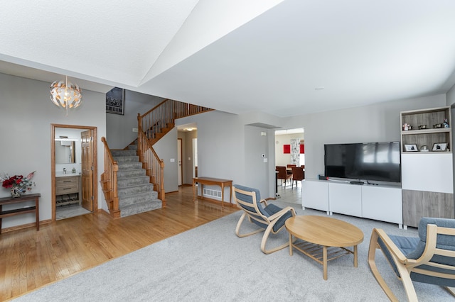 5078 Nicklaus Dr NW, Rochester, MN 55901 - living room with stairs, wood finished floors, and a chandelier