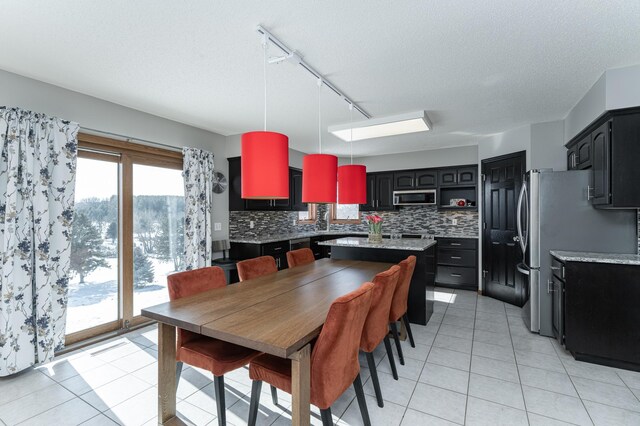 5078 Nicklaus Dr NW, Rochester, MN 55901 - dining space with track lighting, light tile patterned floors, and a textured ceiling