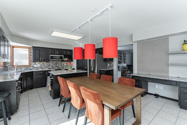 5078 Nicklaus Dr NW, Rochester, MN 55901 - dining area featuring track lighting and light tile patterned floors
