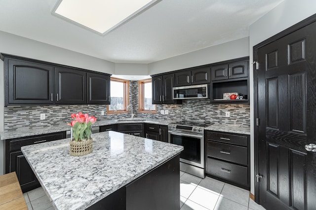 5078 Nicklaus Dr NW, Rochester, MN 55901 - kitchen featuring stainless steel appliances, light tile patterned flooring, and tasteful backsplash