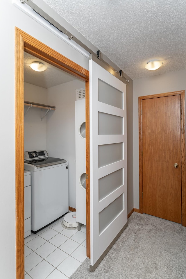 5078 Nicklaus Dr NW, Rochester, MN 55901 - washroom with separate washer and dryer, a barn door, and a textured ceiling