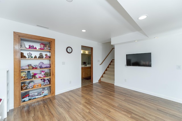 5078 Nicklaus Dr NW, Rochester, MN 55901 - unfurnished living room featuring stairway, light wood-style flooring, and recessed lighting
