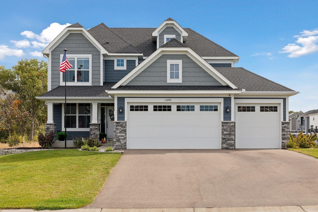 craftsman-style home with a garage and a front yard