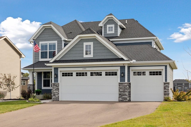 craftsman-style house featuring a garage and a front yard