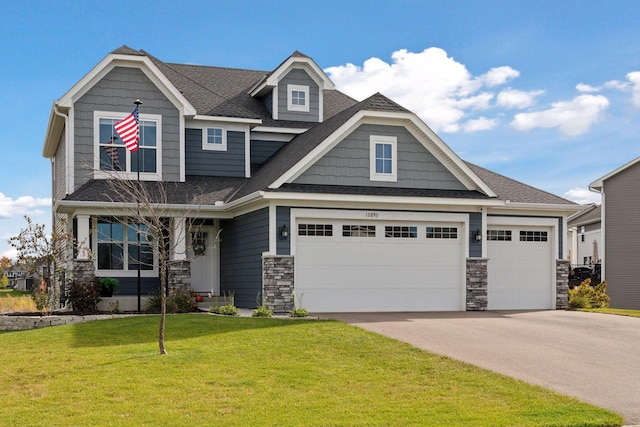 craftsman inspired home featuring a garage and a front yard