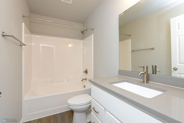 full bathroom with hardwood / wood-style flooring, shower / tub combination, vanity, and toilet