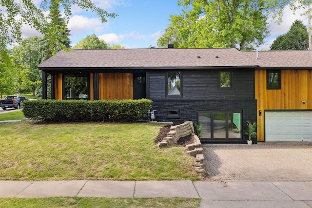 651 Sue Pl, Saint Paul, MN 55116 - view of front of property with decorative driveway, a front lawn, an attached garage, and a shingled roof