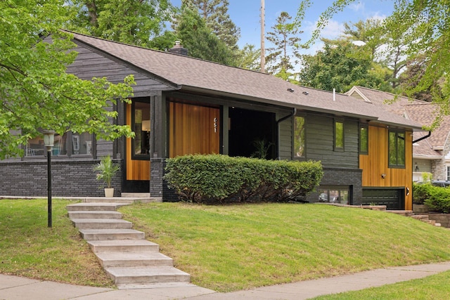 651 Sue Pl, Saint Paul, MN 55116 - view of front of house featuring a front lawn, board and batten siding, a shingled roof, and an attached garage