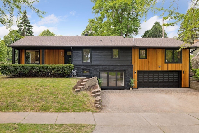 651 Sue Pl, Saint Paul, MN 55116 - view of front of property featuring an attached garage, decorative driveway, a front yard, and roof with shingles