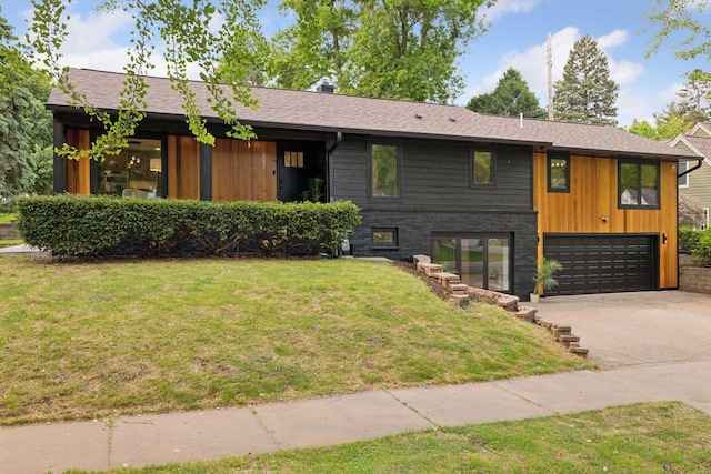 651 Sue Pl, Saint Paul, MN 55116 - view of front of house with an attached garage, a front lawn, driveway, and a shingled roof