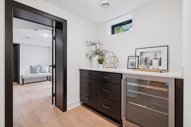 651 Sue Pl, Saint Paul, MN 55116 - indoor dry bar with wine cooler, light wood finished floors, and baseboards
