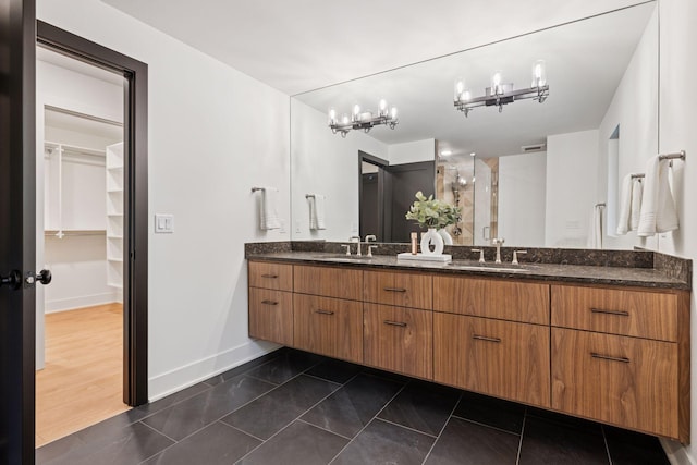 651 Sue Pl, Saint Paul, MN 55116 - full bath featuring double vanity, baseboards, a stall shower, a spacious closet, and a chandelier