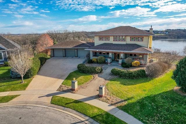 view of front facade featuring driveway, covered porch, a front lawn, and a shingled roof