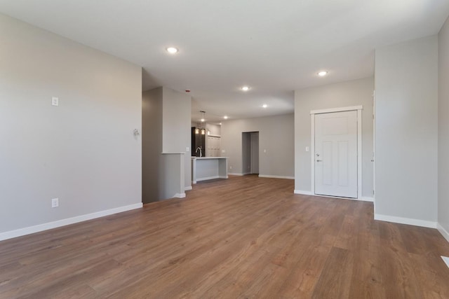 unfurnished living room featuring hardwood / wood-style floors