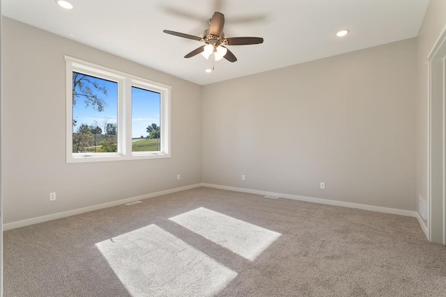 carpeted empty room featuring ceiling fan