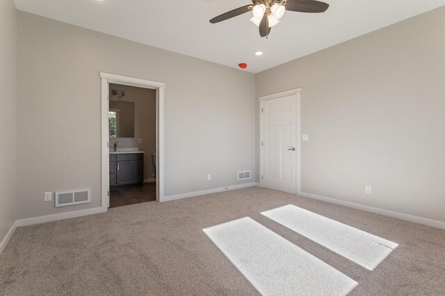 unfurnished bedroom with carpet, sink, and connected bathroom