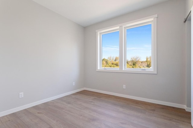 unfurnished room with light wood-type flooring