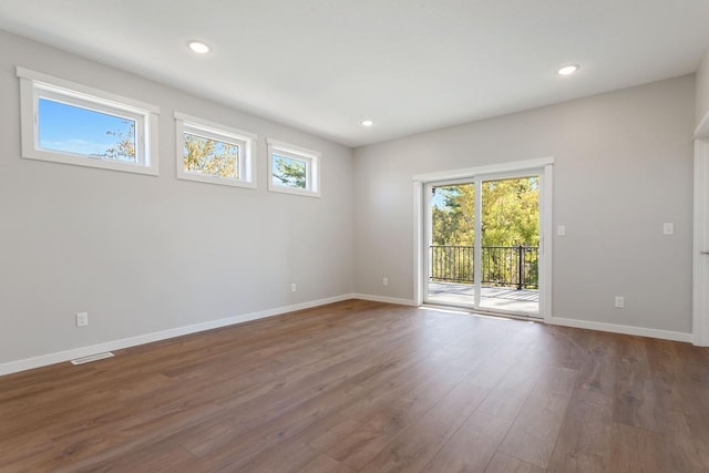 unfurnished room with dark hardwood / wood-style flooring