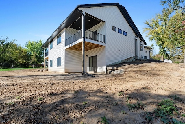 rear view of property with a balcony