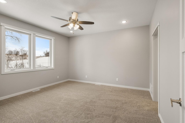 empty room featuring carpet flooring and ceiling fan