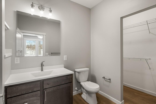 bathroom featuring vanity, hardwood / wood-style floors, and toilet