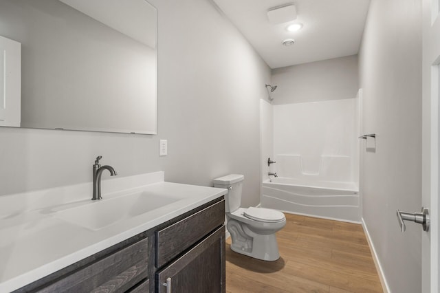 full bathroom featuring vanity, hardwood / wood-style flooring, shower / bathtub combination, and toilet