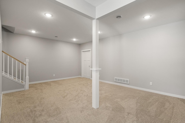 basement featuring light carpet