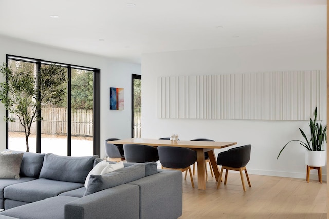 living room with a wealth of natural light and light wood-type flooring