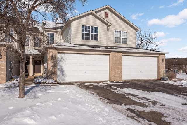 traditional home featuring brick siding and an attached garage