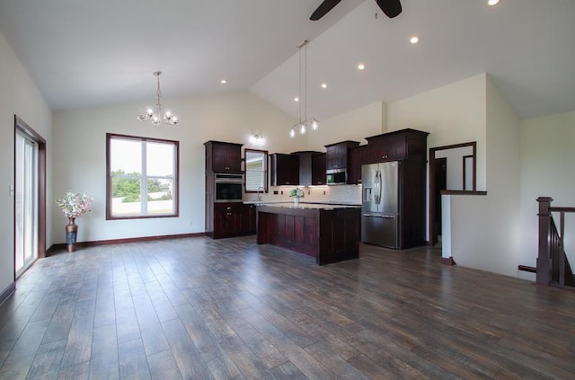 kitchen featuring appliances with stainless steel finishes, decorative light fixtures, sink, dark hardwood / wood-style flooring, and a center island