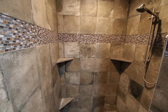 interior details featuring tiled shower