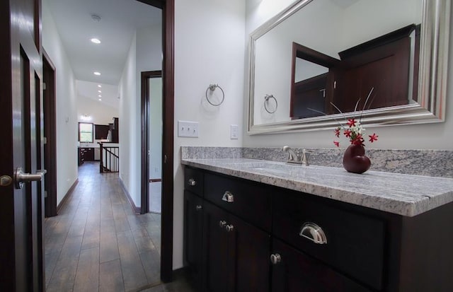 bathroom with hardwood / wood-style flooring and vanity