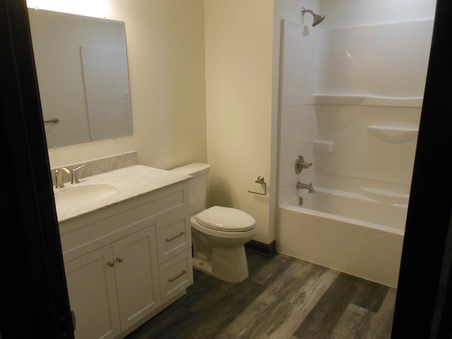 full bathroom with vanity, hardwood / wood-style floors, toilet, and shower / bath combination