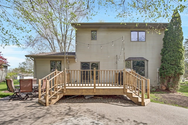 back of house featuring a deck and a patio area