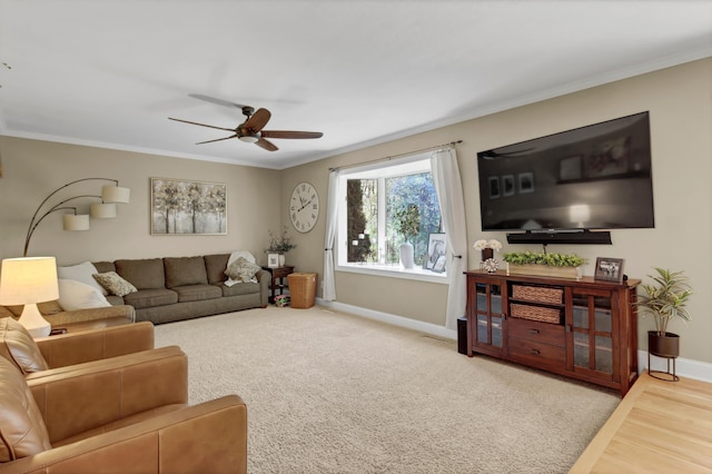 living room with baseboards, ceiling fan, ornamental molding, wood finished floors, and carpet floors