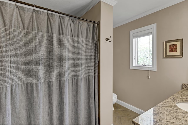 bathroom featuring baseboards, toilet, ornamental molding, tile patterned floors, and vanity