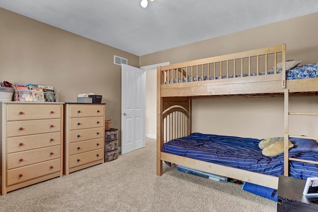 carpeted bedroom featuring visible vents