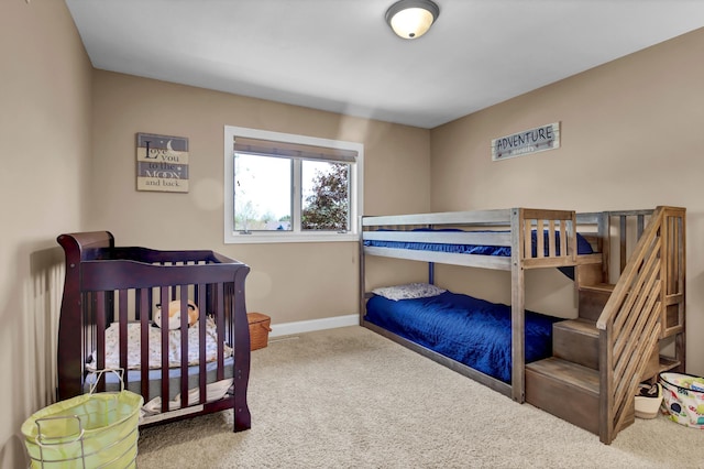 carpeted bedroom featuring baseboards