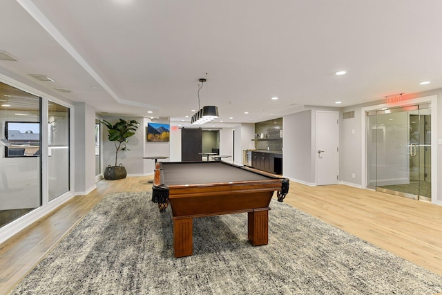 game room with bar area, light wood-type flooring, and billiards