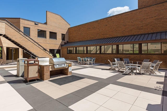 view of patio with an outdoor kitchen, grilling area, and an outdoor fire pit