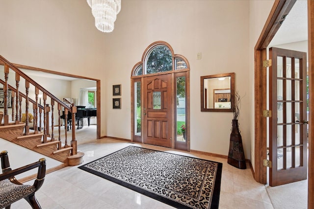 11824 Welters Way, Eden Prairie, MN 55347 - foyer with a high ceiling, light tile patterned floors, stairs, a chandelier, and baseboards