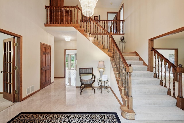 11824 Welters Way, Eden Prairie, MN 55347 - stairway featuring a high ceiling, baseboards, a chandelier, and marble finish flooring