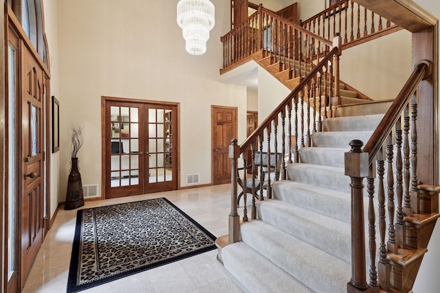 11824 Welters Way, Eden Prairie, MN 55347 - entrance foyer with a high ceiling, french doors, baseboards, stairway, and a chandelier