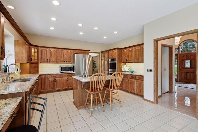 11824 Welters Way, Eden Prairie, MN 55347 - kitchen featuring a sink, stainless steel appliances, a breakfast bar area, recessed lighting, and backsplash