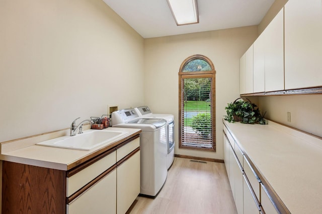 11824 Welters Way, Eden Prairie, MN 55347 - laundry area featuring cabinet space, separate washer and dryer, light wood-type flooring, and baseboards
