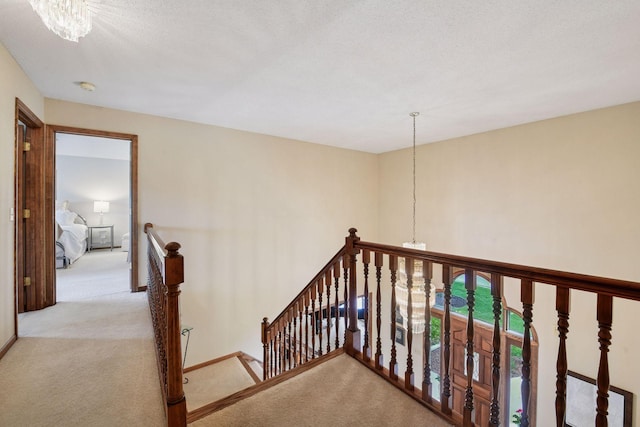 11824 Welters Way, Eden Prairie, MN 55347 - hall featuring an upstairs landing, light carpet, and a chandelier