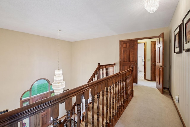 11824 Welters Way, Eden Prairie, MN 55347 - corridor featuring an upstairs landing, light carpet, a chandelier, and baseboards