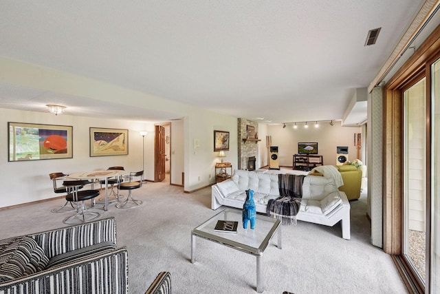 11824 Welters Way, Eden Prairie, MN 55347 - living room featuring light colored carpet, rail lighting, baseboards, and a fireplace