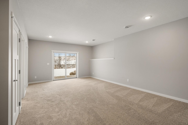 carpeted spare room featuring a textured ceiling